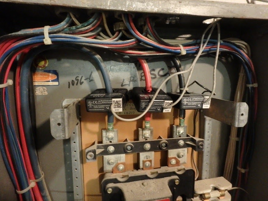 Figure 4. Onset Split-core AC Current Transformer (CTV-x) connected to the incoming feed lines of a three-phase electrical panelboard.