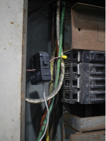 Figure 5. Example of a current sensor attached to a single wire. The wire is connected to a circuit breaker within a panelboard. 